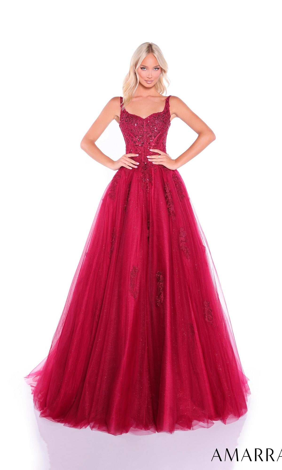 A woman in the Sheer-Corset Long Prom Dress: Amarra 89429—floor-length, sleeveless, red with an embroidered corset bodice and full tulle skirt—stands against a white background.